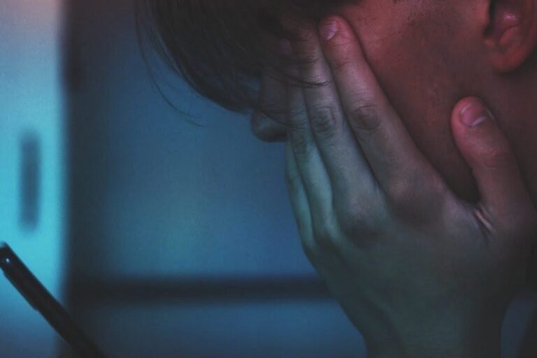 Somebody sad looking at a phone