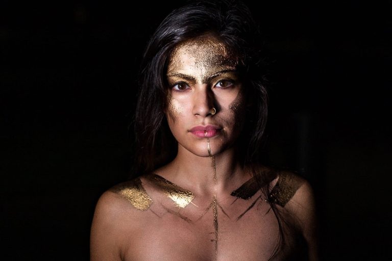 A woman with gold paint on her