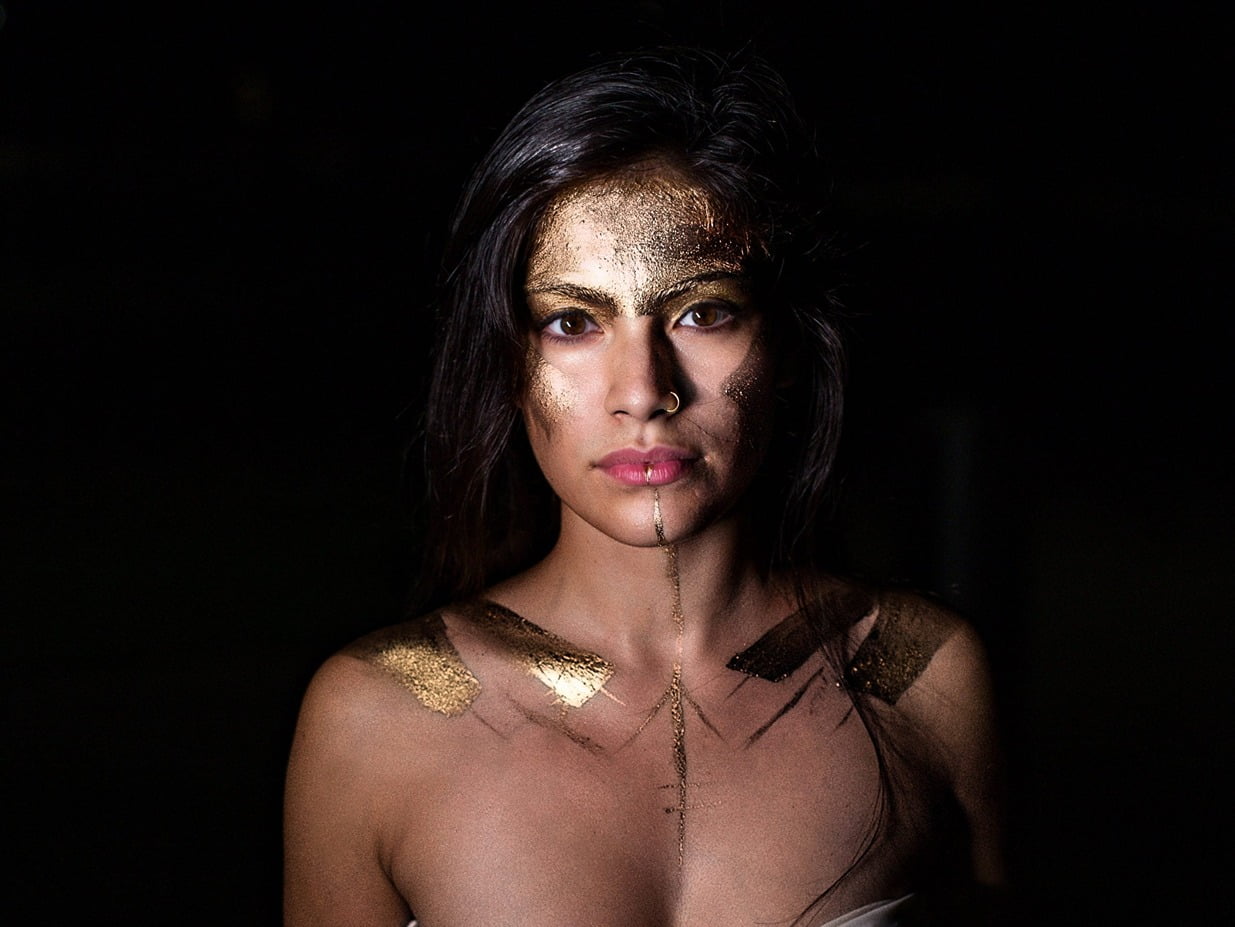 A woman with gold paint on her