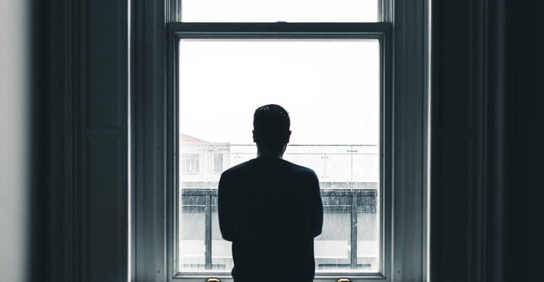 A man looking out a window