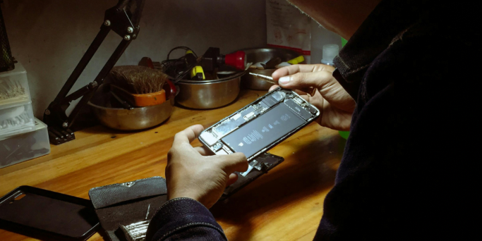 fixing phone man fixing phone